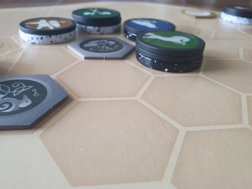 Game coins in a stack, one flipped to show both faces.